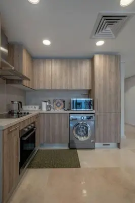 a kitchen with a washer and a dishwasher at Newly Furnished & Bright 2BR Apt: Mangroovy in Hurghada