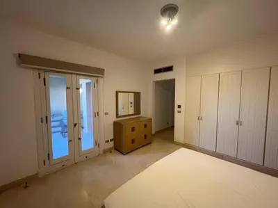 a large room with white cabinets and a dresser at 2BR New Marina Retreat • Private Pool in Hurghada