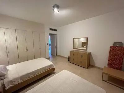 a bedroom with a bed and a dresser and a mirror at 2BR New Marina Retreat • Private Pool in Hurghada