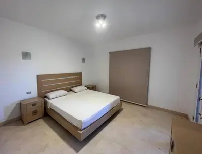 a bedroom with a bed and a nightstand and a bed sidx sidx sidx sidx at 2BR New Marina Retreat • Private Pool in Hurghada
