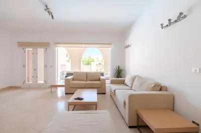 a living room with two couches and a table at 2BR New Marina Retreat • Private Pool in Hurghada
