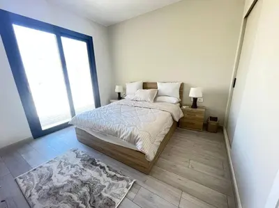 a bedroom with a bed and a large window at Shedwan 2 Bdr Ground Floor in Hurghada
