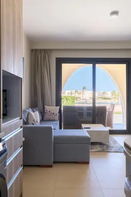 a living room with a couch and a tv at Shedwan 2 Bdr Ground Floor in Hurghada