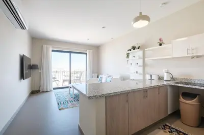 a kitchen with a counter and a large window at Chic Tawila 1BR • Pristine & Modern in Hurghada