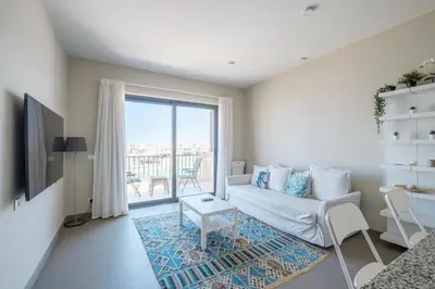 a living room with a couch and a table at Chic Tawila 1BR • Pristine & Modern in Hurghada