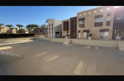 a large parking lot in front of a building at Stylish 1BR • Scarab Main Pool Access in Hurghada