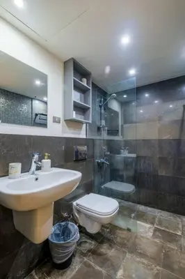 a bathroom with a sink and a toilet and a shower at Stylish 1BR • Scarab Main Pool Access in Hurghada