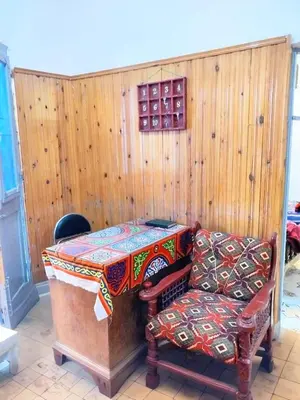 a living room with a table and a chair at Osiris Hotel Luxor \u60a8\u5728\u76e7\u514b\u7d22\u7684\u7b2c\u4e8c\u500b\u5bb6 in Luxor