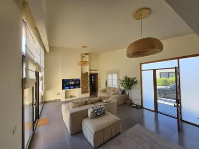a living room with two couches and a tv at Somabay Beach House BW in Hurghada