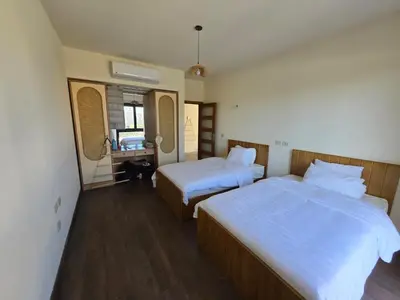 a hotel room with two beds and a bathroom at Somabay Beach House BW in Hurghada