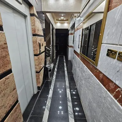a hallway of a building with a tile floor at Dody rent services in Jazīrat al ‘Awwāmīyah