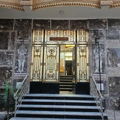 a pair of doors in a building with stairs at Dody rent services in Jazīrat al ‘Awwāmīyah