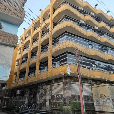 a large building with balconies on the side of it at Dody rent services in Jazīrat al ‘Awwāmīyah