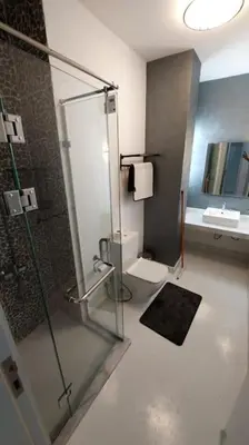 a bathroom with a shower and a toilet and a sink at Modern chalet at el gouna Swan Lake compound with Swimable lagoon view in Hurghada