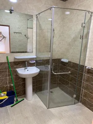 a bathroom with a glass shower and a sink at Quiet quarter and private beach in Hurghada