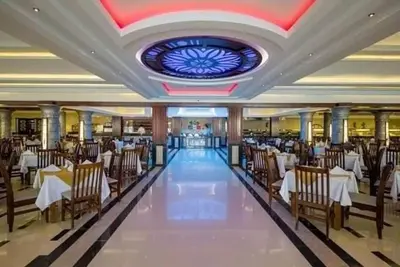 a dining room with tables and chairs and a ceiling at ميراج in Hurghada