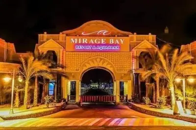 a large building with palm trees in front of it at ميراج in Hurghada