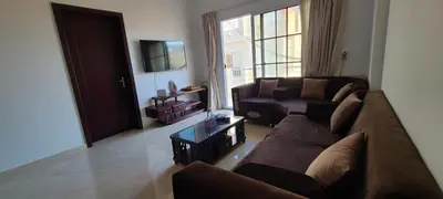 a living room with a couch and a table at Luxury Two Bedrom Apartment in Hurghada