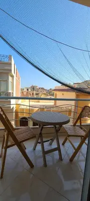 a picnic table on a balcony with a view at Luxury Two Bedrom Apartment in Hurghada