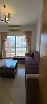 a living room with a purple couch and a table at Hurghada Al Hilal District in Hurghada