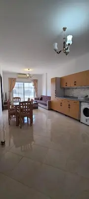 a large living room with a table and a kitchen at Hurghada Al Hilal District in Hurghada