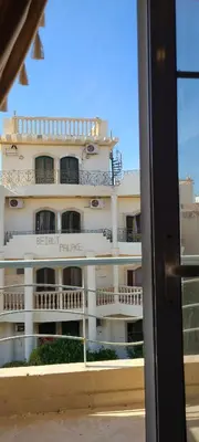 a large white building with balconies and a window at Hurghada Al Hilal District in Hurghada