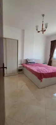 a bedroom with a large bed with a red blanket at Hurghada Al Hilal District in Hurghada