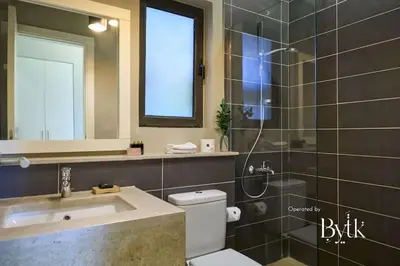 a bathroom with a toilet and a sink and a shower at BYTK - Villa La Calma in Hurghada