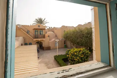 a view from a window of a house with a yard at The Downtown Getaway Studio in Hurghada