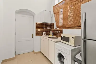 a kitchen with a washing machine and a microwave at The Downtown Getaway Studio in Hurghada