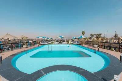 a large swimming pool on the roof of a hotel at Five Stars Nile Cruise from Luxor to Aswan 4 nights in Aswan