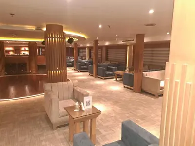 a large room with couches and a table in a building at Five Stars Nile Cruise from Luxor to Aswan 4 nights in Aswan