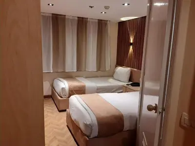 a hotel room with two beds and a couch at Five Stars Nile Cruise from Luxor to Aswan 4 nights in Aswan