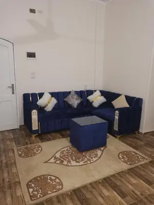 a blue couch in a living room with a rug at Hmmam in Quseir