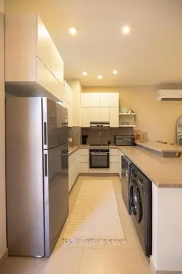 a kitchen with a stainless steel refrigerator and a dishwasher at El Gouna at Birdnest in Hurghada