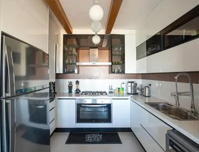 a kitchen with white cabinets and a stove top oven at El Gouna at Birdnest in Hurghada