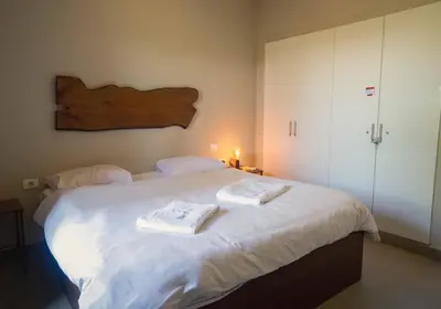 a bedroom with a large white bed with towels on it at El Gouna at Birdnest in Hurghada