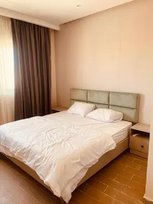 a bedroom with a large white bed with a window at Luxury Chalet in Alsaraya, Overlooking All of Sahl Hasheesh with Stunning Pool & Red Sea Views in Hurghada