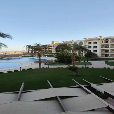 a view of a park with palm trees and a building at Luxury Chalet in Alsaraya, Overlooking All of Sahl Hasheesh with Stunning Pool & Red Sea Views in Hurghada