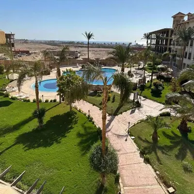 an aerial view of a park with two pools and palm trees at Luxury Chalet in Alsaraya, Overlooking All of Sahl Hasheesh with Stunning Pool & Red Sea Views in Hurghada