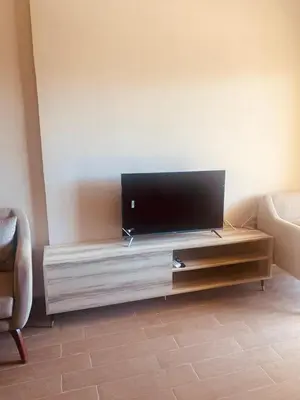 a living room with a flat screen tv on a entertainment center at Luxury Chalet in Alsaraya, Overlooking All of Sahl Hasheesh with Stunning Pool & Red Sea Views in Hurghada