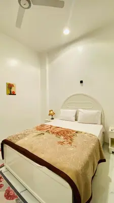 a white bedroom with a large bed in a room at Star - private apartments in Luxor