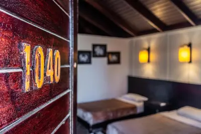 a room with two beds and two tables in it at Abu Dabbab Lodge in Abu Dabab