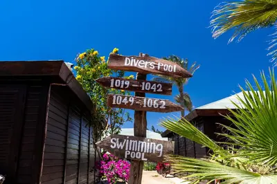 a street sign in front of a swimming pool at Abu Dabbab Lodge in Abu Dabab