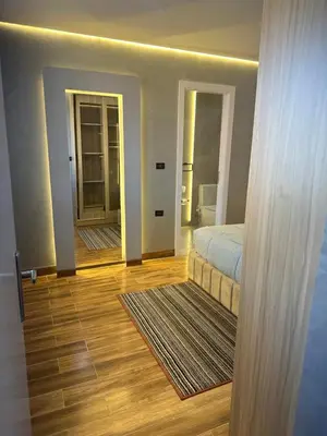 a bedroom with a bed and a hallway with a mirror at Mashrabiya one bed room apartment in Hurghada