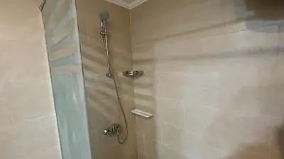 a shower with a glass door in a bathroom at Dani Apartment at Aldau Heights in Hurghada