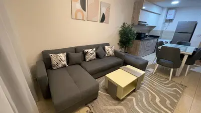 a living room with a couch and a table at Dani Apartment at Aldau Heights in Hurghada