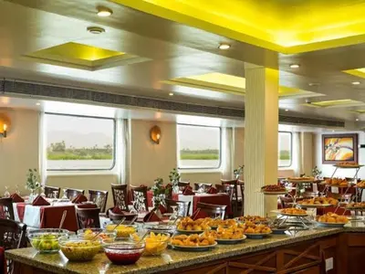 a restaurant with a buffet line with food on it at Nile Cruise 3 nights From Aswan to Luxor in Aswan