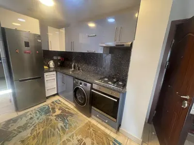 a kitchen with a stove and a washer and dryer at Galaxy Aldau heights 2 bedrooms in Hurghada