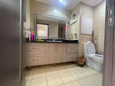 a bathroom with a sink and a toilet and a mirror at Galaxy Aldau heights 2 bedrooms in Hurghada